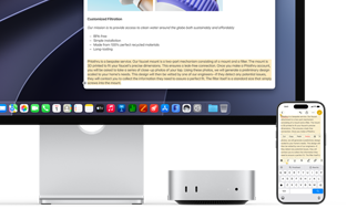 Mac mini front, tucked under Studio Display, an iPhone sits to the right of the device and the display, text selected with cut, copy, paste, and AutoFill commands above on iPhone matches highlighted text on display, showcasing Universal Clipboard