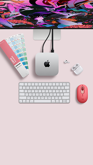 Mac mini, top, silver aluminum, rounded corners, glossy black Apple logo centered, connected by cord, Studio Display partially visible on top, AirPod 4, open, Pantone color swatches, and numeric keyboard and mouse